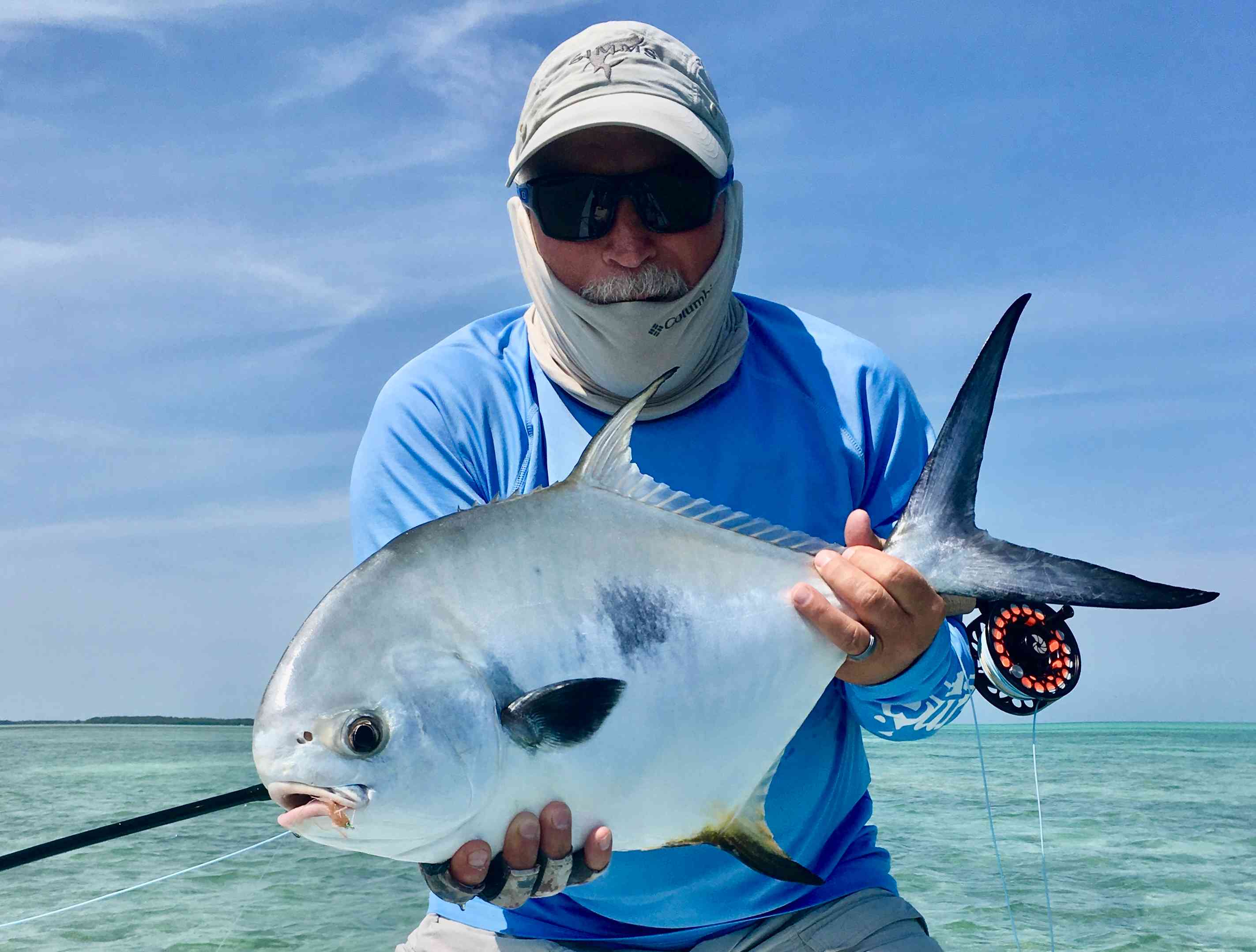 Angler with a permit caught on fly