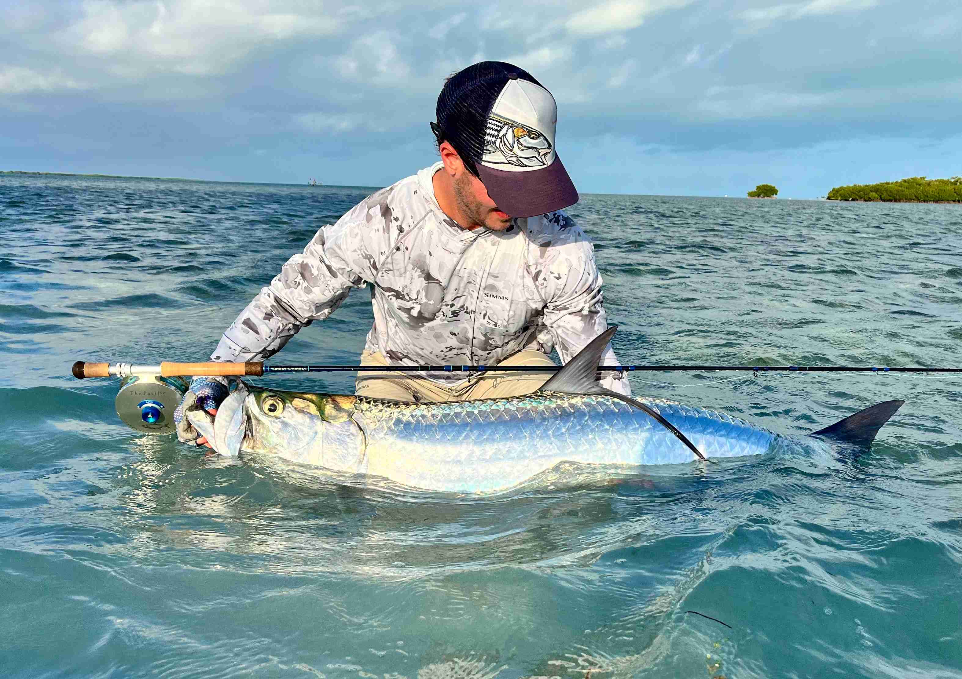 Angler with a tarpon caught on fly